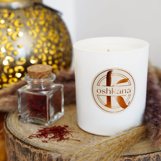 oshkana tonka saffron candle next to saffron jar